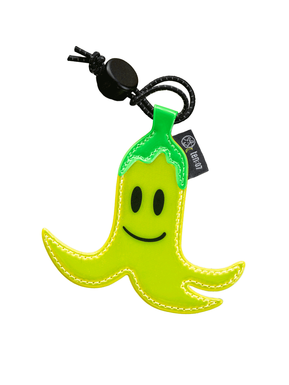 A bright yellow-green smiley face banana-shaped keychain or bag charm with a black cord, black eye and mouth details, white stitching.